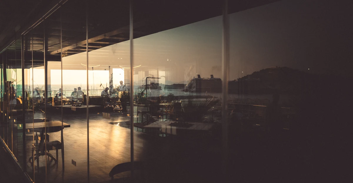 Golden evening light reflected through restaurant windows